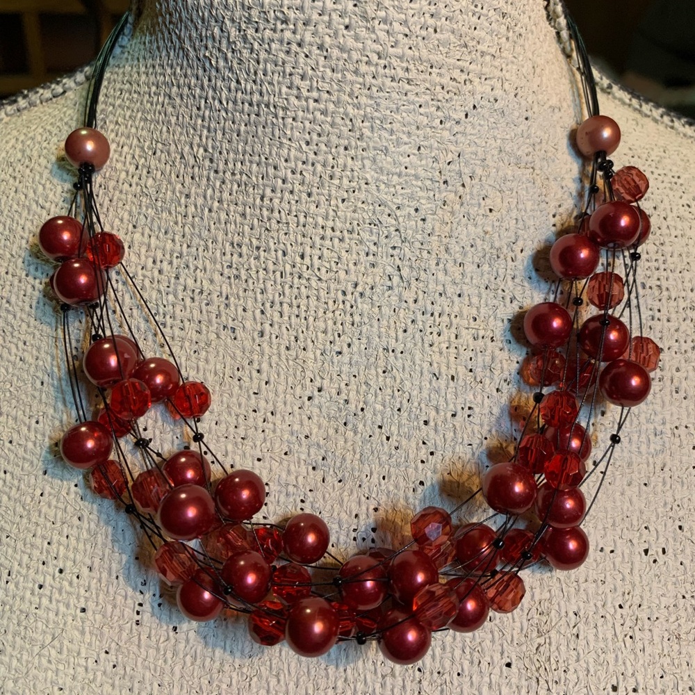 Red Beaded strands on black wire.